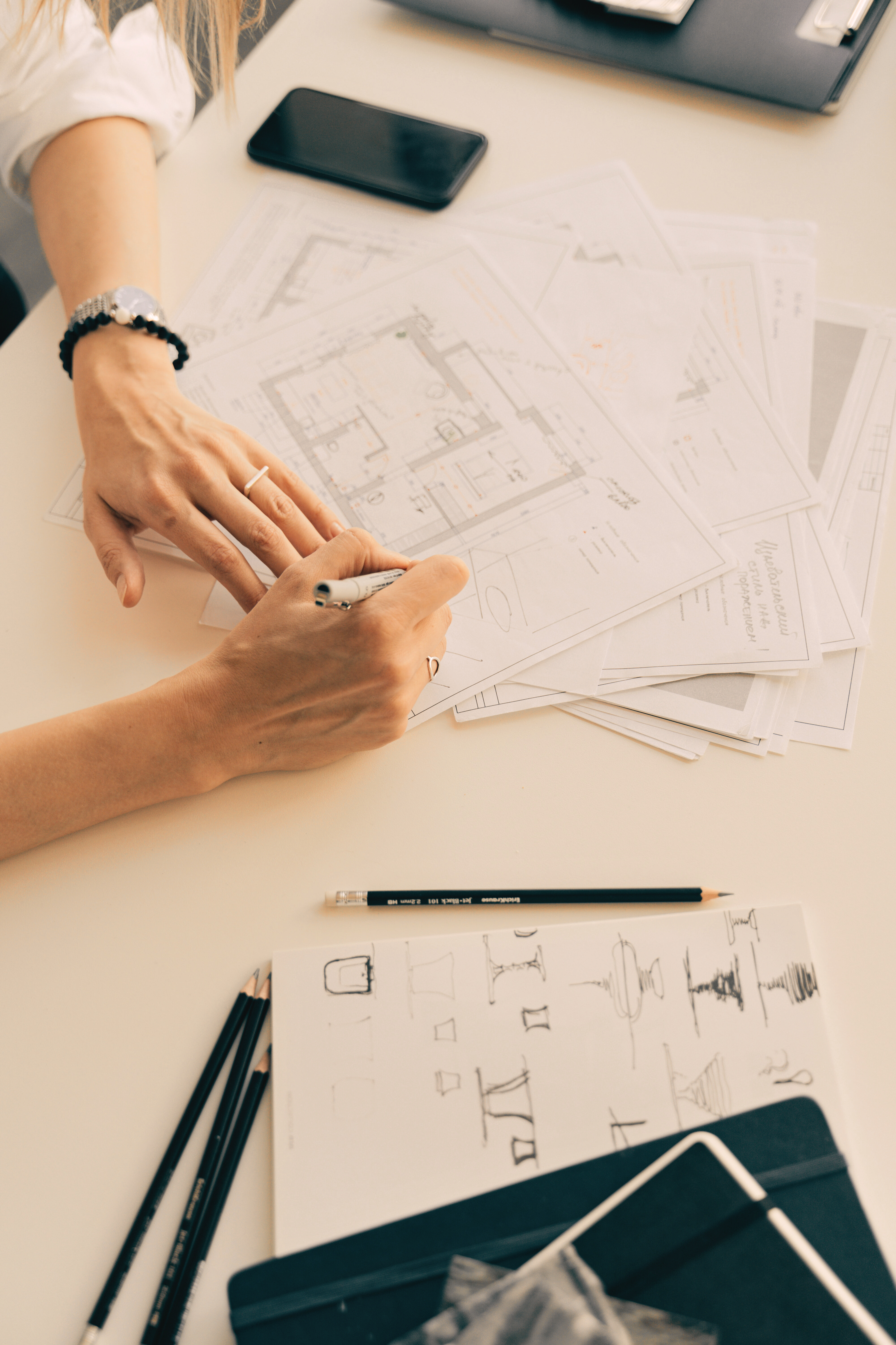 Top down view of designer marking up floor plans